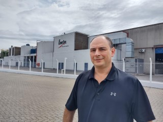 Clovis Tanganelli in front of an EnerSys manufacturing facility 